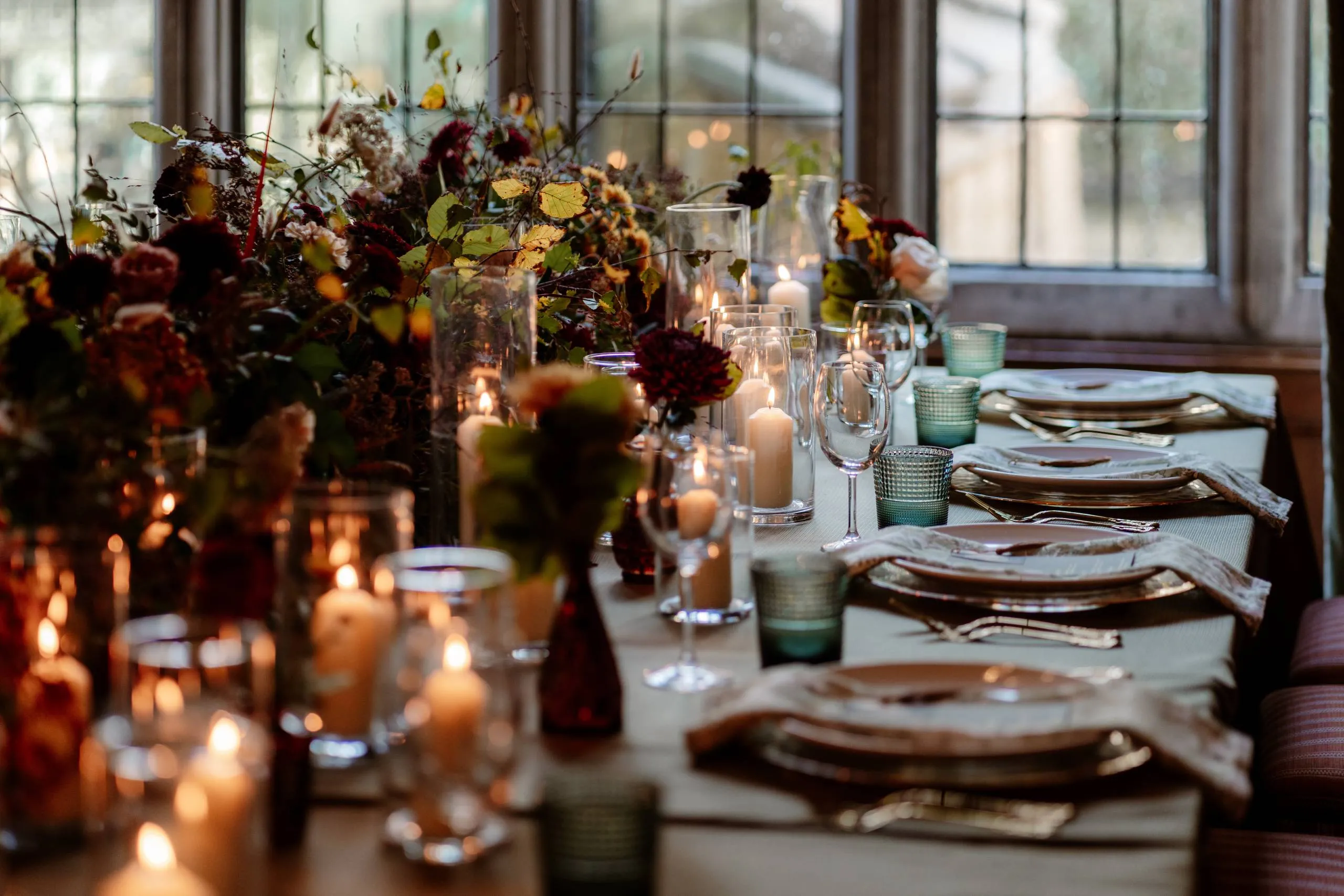 An autumn wedding tablescape with candles and meadow-style flowers
